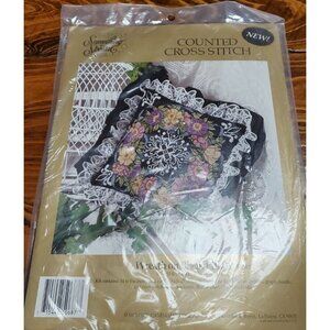 Something Special Counted Cross Stitch Kit #50687 wreath on black pillow.